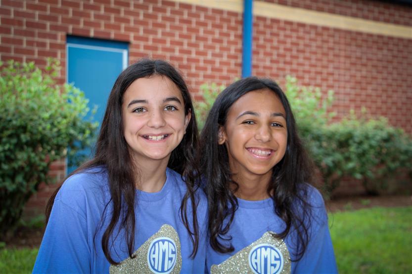 Two students smile